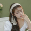 Elegant ribbon headband for women, a stylish hair accessory perfect for adding a chic touch to any outfit.